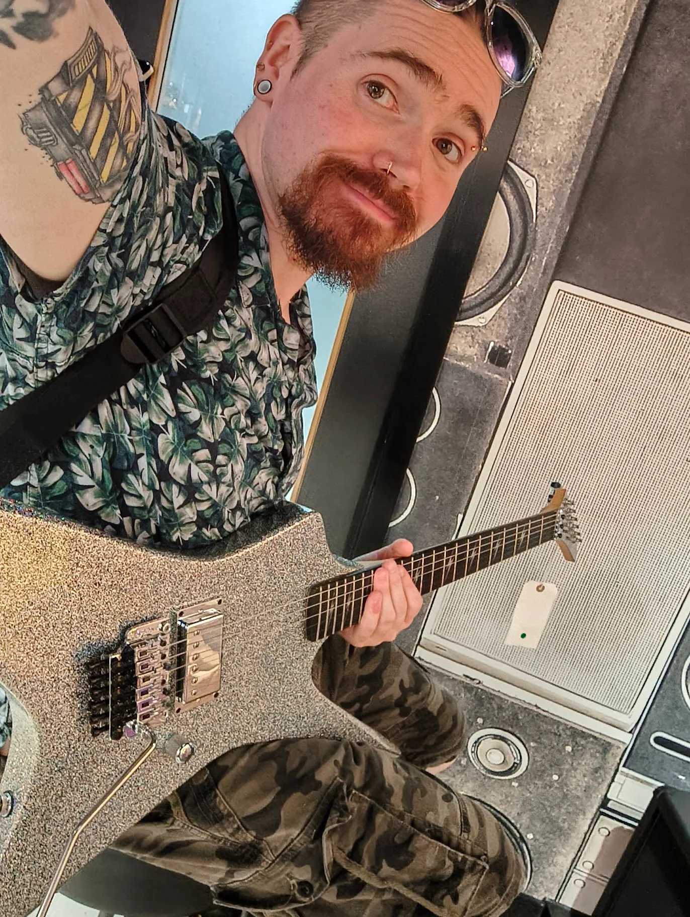 JB Toner holding an electric guitar in a studio
